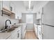 White kitchen with stainless steel appliances and quartz countertops at 2634 Country Estates Dr # 17, Indianapolis, IN 46227