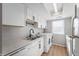 White kitchen with stainless steel appliances and quartz countertops at 2634 Country Estates Dr # 17, Indianapolis, IN 46227