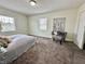 Spacious bedroom with gray carpet and large window at 2705 Shriver Ave, Indianapolis, IN 46208