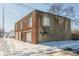 Brick and block building with garage door and snow on the ground at 3324 Prospect St, Indianapolis, IN 46203