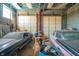 Garage with two large roll-up doors and multiple classic cars inside at 3324 Prospect St, Indianapolis, IN 46203