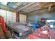 Garage interior with classic cars, storage items, and a loft area at 3324 Prospect St, Indianapolis, IN 46203