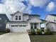 Two-story house with gray siding, white trim, and a two-car garage at 3406 Preakness St, Whitestown, IN 46075