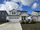 Two-story house with gray siding, white trim, and a two-car garage at 3406 Preakness St, Whitestown, IN 46075