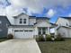 Two-story house with gray siding, white trim, and a two-car garage at 3406 Preakness St, Whitestown, IN 46075