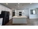 Modern kitchen with white cabinets, quartz countertops, and black appliances at 3406 Preakness St, Whitestown, IN 46075