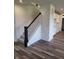 Elegant staircase with dark wood railing and carpeted steps at 3406 Preakness St, Whitestown, IN 46075
