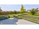 View of back deck with gray wood and railing, and a beautiful green lawn at 3460 Limelight Ln, Whitestown, IN 46075