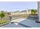 Backyard deck with gray railing, with a view of the fenced yard and neighboring homes at 3460 Limelight Ln, Whitestown, IN 46075