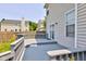 Large backyard deck with gray railings leading to a fenced yard and sliding glass doors at 3460 Limelight Ln, Whitestown, IN 46075