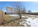 Backyard of house with a tree, patchy snow, and wooden fence at 3460 Limelight Ln, Whitestown, IN 46075