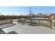 Large backyard with a deck, wooden fence, and partial snow cover at 3460 Limelight Ln, Whitestown, IN 46075