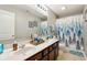 Bathroom with a double vanity, shower/tub combo, and blue tree shower curtain at 3460 Limelight Ln, Whitestown, IN 46075