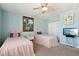 Twin bedroom with light blue walls, white dresser, and pink bedspreads at 3460 Limelight Ln, Whitestown, IN 46075