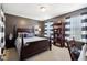 Elegant bedroom featuring a dark wood bed, built-in shelves, and blue striped curtains at 3460 Limelight Ln, Whitestown, IN 46075