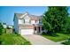 Charming two-story home featuring a two-car garage and well-manicured front lawn at 3460 Limelight Ln, Whitestown, IN 46075