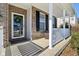 Inviting front porch with brick columns and white railing at 3460 Limelight Ln, Whitestown, IN 46075