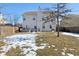 Rear view of a two-story house with a backyard and some snow at 3460 Limelight Ln, Whitestown, IN 46075
