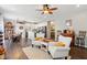 Open concept kitchen and living area with a teal island and hardwood floors at 3460 Limelight Ln, Whitestown, IN 46075