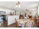 Open concept kitchen with a round dining table and hardwood floors at 3460 Limelight Ln, Whitestown, IN 46075
