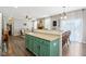 Open concept kitchen with a teal island and a view of the living room at 3460 Limelight Ln, Whitestown, IN 46075
