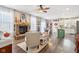 Open concept kitchen and living area with a teal island and hardwood floors at 3460 Limelight Ln, Whitestown, IN 46075