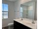 Bright bathroom with double sink vanity, large mirror, toilet and hardwood floors at 371 Traditions Pass, Greenwood, IN 46143