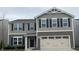 Charming two-story home with a two-car garage and black shutters at 371 Traditions Pass, Greenwood, IN 46143
