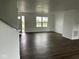 Bright living room with dark wood floors and large windows at 371 Traditions Pass, Greenwood, IN 46143