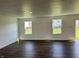 Bright living room featuring hardwood floors and windows overlooking the backyard at 371 Traditions Pass, Greenwood, IN 46143
