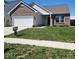 Charming single-story home with brick accents, a well-manicured lawn, and a 'Tucker' sign at 5154 Bramwell Ln, Whitestown, IN 46075