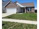 Charming single-story home with a well-maintained lawn and a two-car garage with a brick facade at 5154 Bramwell Ln, Whitestown, IN 46075
