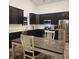 Eat-in kitchen with dark cabinetry and stainless steel appliances at 5154 Bramwell Ln, Whitestown, IN 46075