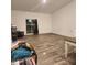Large living area with wood-look tile flooring and sliding glass doors at 5154 Bramwell Ln, Whitestown, IN 46075