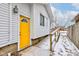 Side entrance with yellow door and wooden ramp at 5210 E 10Th St, Indianapolis, IN 46219