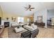 Bright living room featuring a fireplace, modern white sofas, decorative wallpaper accent, and light wood flooring at 6540 Avalon Blvd, Avon, IN 46123