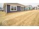 New construction home showcasing vinyl siding, white window trim and a large lawn at 6636 Sulgrove Pl, Indianapolis, IN 46221