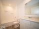 Bathroom with modern fixtures, vanity, and combined shower and tub at 6636 Sulgrove Pl, Indianapolis, IN 46221