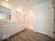 Modern bathroom with dual sinks, white cabinets, and a glass-enclosed shower offers a serene and functional space at 6636 Sulgrove Pl, Indianapolis, IN 46221
