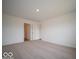 Comfortable bedroom with plush carpeting and neutral colors offers a versatile space for relaxation and personalization at 6636 Sulgrove Pl, Indianapolis, IN 46221