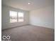 Bright and airy bedroom features large windows for natural light and plush carpeting for a comfortable feel at 6636 Sulgrove Pl, Indianapolis, IN 46221