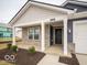 Charming front porch with columns and landscaping at 6636 Sulgrove Pl, Indianapolis, IN 46221
