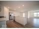 A contemporary kitchen features stainless steel appliances, white cabinets and an island with light countertops at 6636 Sulgrove Pl, Indianapolis, IN 46221