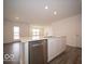 Bright kitchen features a stainless steel dishwasher and sink in a large island, perfect for food preparation and entertaining at 6636 Sulgrove Pl, Indianapolis, IN 46221