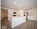 Bright kitchen with white cabinets, stainless steel appliances, and center island with sink at 6636 Sulgrove Pl, Indianapolis, IN 46221