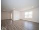 A well-lit living area features modern flooring, neutral paint, recessed lighting, and a view into the kitchen at 6636 Sulgrove Pl, Indianapolis, IN 46221