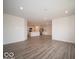 This spacious living area features an open design with recessed lighting, neutral paint, and modern floors at 6636 Sulgrove Pl, Indianapolis, IN 46221