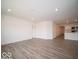 Open-concept living room featuring new wood-look floors, neutral paint, and recessed lighting at 6636 Sulgrove Pl, Indianapolis, IN 46221