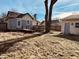Backyard featuring a deck, mature tree, and detached garage under a blue sky at 704 S Ohio St, Sheridan, IN 46069