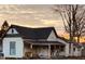 Charming 1-story home with a wrap-around porch and unique architectural details at 704 S Ohio St, Sheridan, IN 46069
